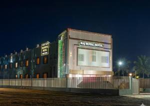 a building with lights on the side of it at night at Raj Royal Hotel in Nagpur