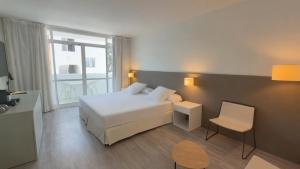a hotel room with a bed and a window at Prinsotel Alba & Spa in Cala d´Or +108 photos