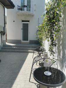 a patio with a table and chairs and a building at Happy Home1 in Cahul