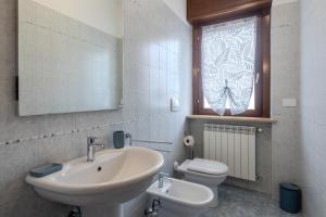 a bathroom with a sink and a toilet and a window at Turin Airport apt B in Leinì +36 photos