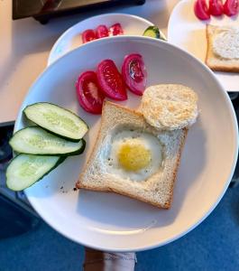 a plate of toast with an egg and tomatoes at Gatto in Bishkek