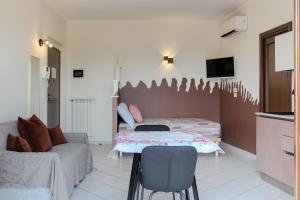 a living room with a table and a couch at Turin Airport apt B in Leinì