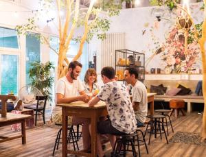 a group of people sitting at a table in a restaurant at Wombat's City Hostel Munich Hauptbahnhof in Munich