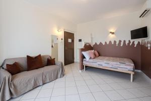 a living room with a couch and a tv at Turin Airport apt B in Leinì