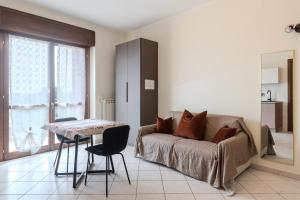 a living room with a couch and a table at Turin Airport apt B in Leinì