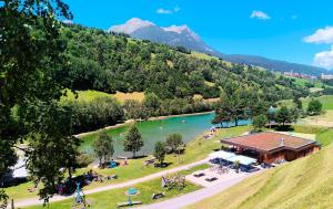 an aerial view of a lake with a lodge at Apartment Keller in Savognin