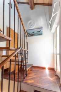 a staircase in a house with wood floors and a ceiling at Dimora RAVENNA CORTE CHARME Diaz in Ravenna +5 photos