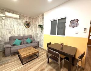 a living room with a couch and a table at close to beach and 15 mints to la rambla by tren in Sant Adria de Besos
