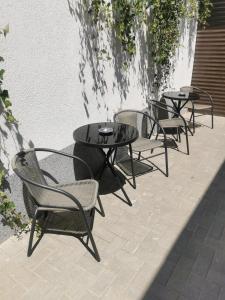 a group of tables and chairs on a patio at Sweet home 1 in Cahul