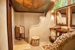 a room with a mirror and a table and a stool at Exploreans Mara River Camp in Musiara Campsite