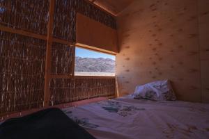 a small room with a bed and a window at Eden Camp Abu Galum in Dahab