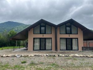 a large house with windows on the side of it at Forest Edge in Borjomi