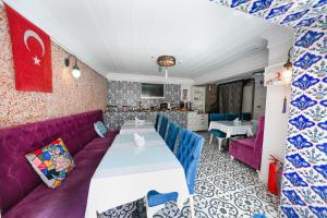 a dining room with a table and purple couch at Ersari Hotel in Istanbul