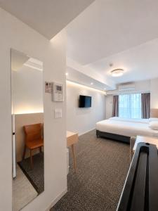 a hotel room with a bed and a desk at Hotel Arashi Nippombashi 1 No006 in Osaka