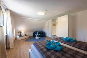 a bedroom with two beds with blue flowers on them at FeWo-Dierhagen in Prerow