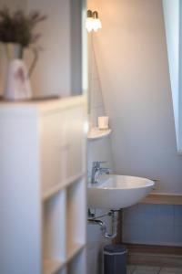 a bathroom with a sink and a mirror at FeWo-Dierhagen in Prerow