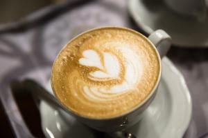 a cup of coffee sitting on a plate at Il Duomo Luxury Suite in Pietrasanta +33 photos