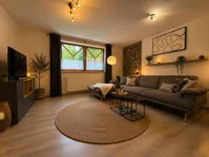 a living room with a couch and a table at Chalet Zugspitzblick in Lermoos
