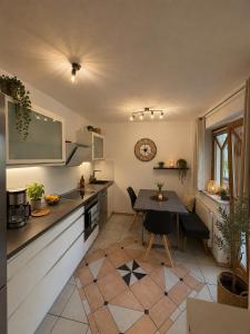 a kitchen with a table and a dining room at Chalet Zugspitzblick in Lermoos