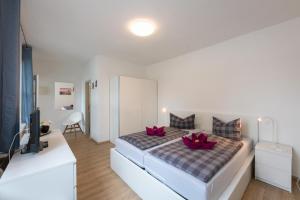 a bedroom with a bed with red flowers on it at FeWo-Zingst in Prerow