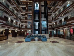 a large lobby with blue couches in a building at Solar Residency, Srinagar in Srinagar