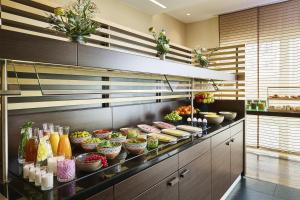 a kitchen with a bunch of food on display at NH Berlin Potsdamer Platz in Berlin