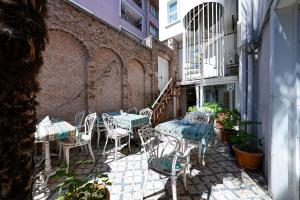 a patio with tables and chairs on a building at Ersari Hotel in Istanbul