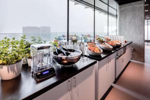 a kitchen with a counter with a blender on it at nhow Amsterdam Rai in Amsterdam +98 photos