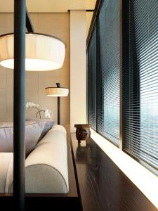 a bedroom with a bed and a large window at The Puli Hotel And Spa in Shanghai