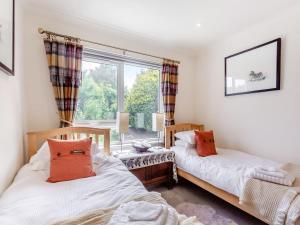 two beds in a room with a window at Beautiful Highland Sanctuary in Embo