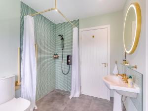 a white bathroom with a shower and a sink at Beautiful Highland Sanctuary in Embo +94 photos