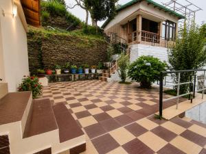 a courtyard with a checkered floor and a house at Hotel Hill Top Palace in Lansdowne