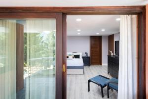 a bedroom with a bed and a sliding glass door at Easylife - Como Villa Sofia Apartments in Como