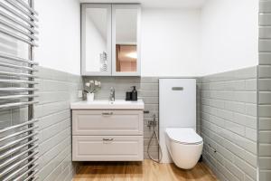 a bathroom with a white sink and a toilet at Easylife - Como Villa Sofia Apartments in Como