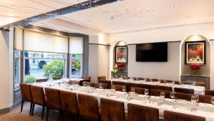 a conference room with a long table and chairs at Great Western Hotel Aberdeen in Aberdeen