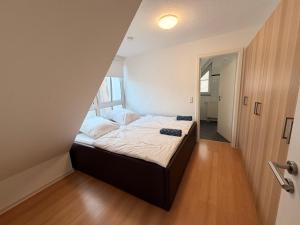 a bedroom with a bed in a small room at Generations Holiday City Lofts am Neumarkt Kölner Straße 23a in Attendorn +19 photos