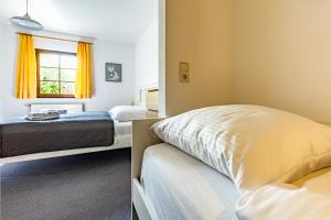 a bedroom with two beds and a window at Henriette in Ahrenshoop