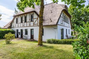 an old white house with a thatched roof at Henriette in Ahrenshoop