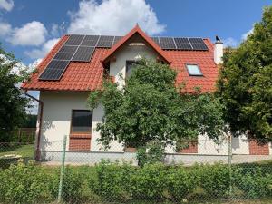 a house with solar panels on top of it at Kubanka dom pokoje apartamenty in Płocice
