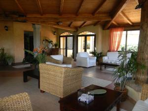 a living room with white furniture and a wooden ceiling at Relais Fenicottero Rosa in Porto San Paolo