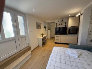 a living room with a couch and a kitchen at House Marin - by the beach in Igrane