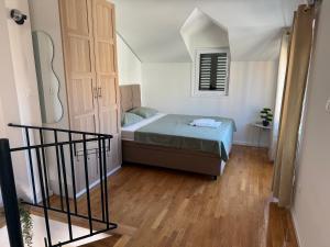a small bedroom with a bed and a window at House Marin - by the beach in Igrane