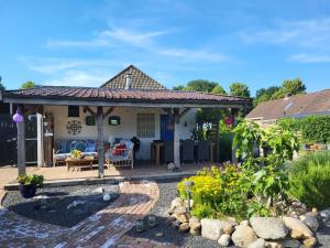 a house with a pavilion in a garden at Bed & Breakfast de Runde in Emmer-Compascuum