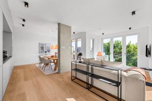 a kitchen and living room with white walls and windows at Ferienwohnung Seaside App 9 List auf Sylt in List