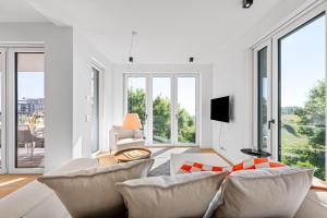 a living room with white furniture and large windows at Ferienwohnung Seaside App 9 List auf Sylt in List +36 photos