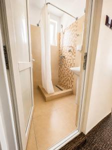 a bathroom with a shower and a sink at Casa Mario in Eforie Nord