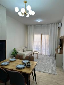 a living room with a table and a couch at Chorvoq Darvozasi touristic complex in Chorwoq