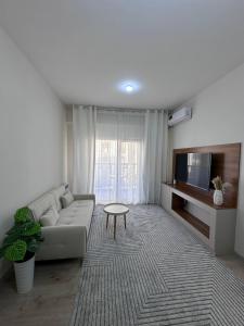 a living room with a couch and a tv at Chorvoq Darvozasi touristic complex in Chorwoq