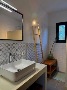 a bathroom with a white sink and a mirror at Can Jondalet in Sant Josep +21 photos