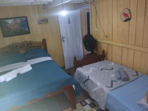 a bedroom with two beds in a room at Hospedagem coqueioros in Soure